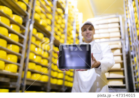 Worker shows an empty screen digitizer in stock cheese 47354015