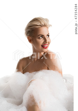 Pretty blonde having bath isolated view 47354284