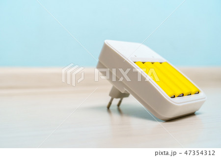 Picture of charger with two yellow batteries Picture of charger with two yellow batteries 47354312
