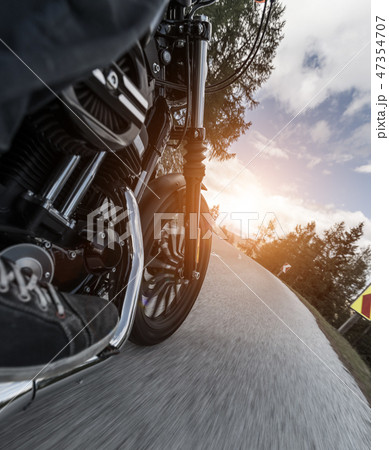 Detail of motorcycle driving in Alpine road Detail of motorcycle driving in Alpine road 47354707