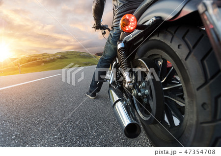 Detail of motorcycle driving in Alpine road Detail of motorcycle driving in Alpine road 47354708