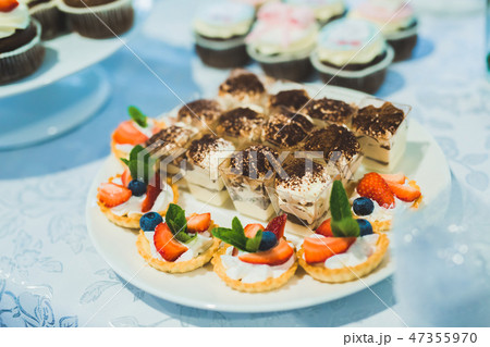 Delicious sweets on wedding candy buffet with desserts, cupcakes Delicious sweets on wedding candy buffet with desserts, cupcakes 47355970