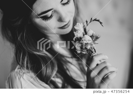 Beautiful bride wearing fashion wedding dress with feathers with luxury delight make-up and Beautiful bride wearing fashion wedding dress with feathers with luxury delight make-up and 47356254