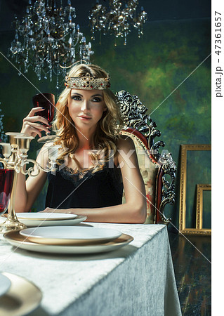 young blond woman wearing crown in fairy luxury interior with empty antique frames total wealth young blond woman wearing crown in fairy luxury interior with empty antique frames total wealth 47361657