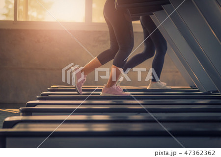 Close-up leg of Women running in machine treadmill Close-up leg of Women running in machine treadmill 47362362