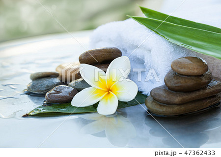 Leaves on the white towel. Spa objects and stones 47362433