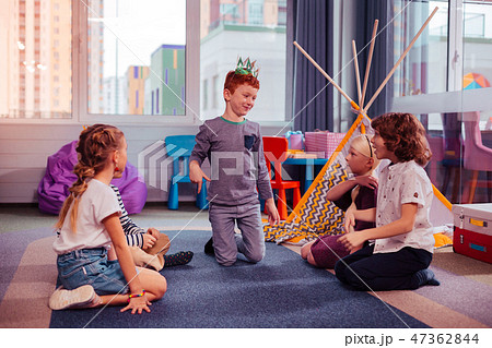 Handsome red-haired boy standing in the middle of room 47362844