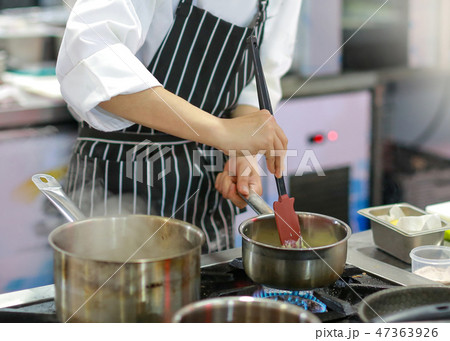 Chef cooking food in the kitchen, preparing food Chef cooking food in the kitchen, preparing food 47363926