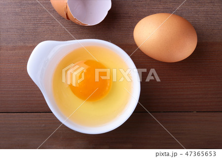 raw egg in white bowl ingredients for cooking. concept. Top view. raw egg in white bowl ingredients for cooking. concept. Top view. 47365653