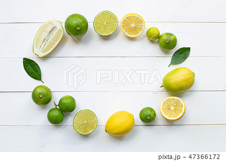 Ripe lemons and limes on white wooden. 47366172