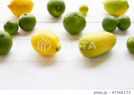 Ripe lemons and limes on white wooden. 47366173
