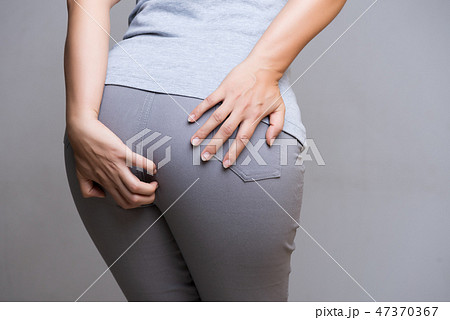 Woman suffering from hemorrhoids 47370367