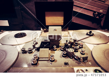 Film tape spooled on vintage cinematic reel. Film tape spooled on vintage cinematic reel. 47371053
