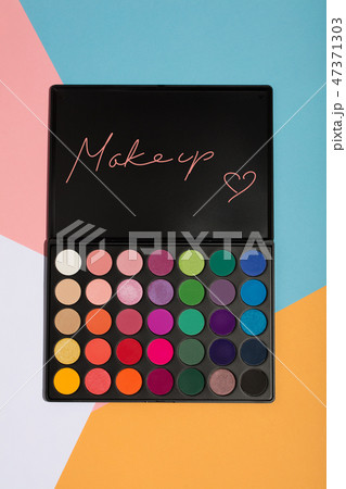 Makeup palette on a colorful geometrical background. Makeup palette on a colorful geometrical background. 47371303