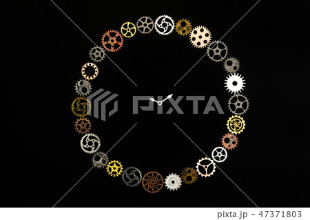 Simple clock made out of little cogwheels. Simple clock made out of little cogwheels. 47371803