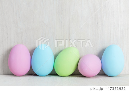 Pastel Easter eggs on wooden table. Pastel Easter eggs on wooden table. 47371922