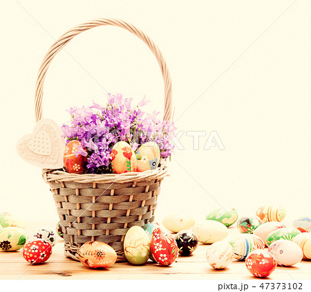Colorful hand painted Easter eggs in basket and on wood. Handmade vintage decoration 47373102
