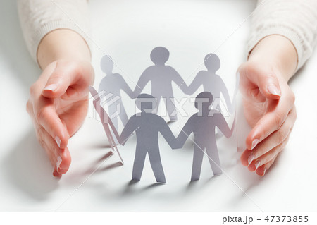 Paper people surrounded by hands in gesture of protection. Concept of insurance 47373855