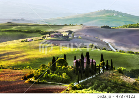 Tuscany landscape at sunrise. Tuscan farm house, vineyard, hills. Tuscany landscape at sunrise. Tuscan farm house, vineyard, hills. 47374122