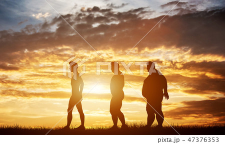 Three men silhouettes with different body types on a sunset sky Three men silhouettes with different body types on a sunset sky 47376353