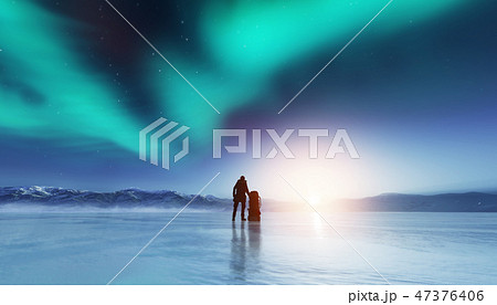 Adventurous man standing with a backpack, looking at aurora. Adventurous man standing with a backpack, looking at aurora. 47376406
