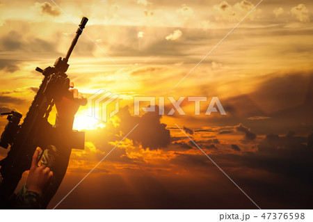 Soldier in combat shooting with his weapon, rifle. War, army concept Soldier in combat shooting with his weapon, rifle. War, army concept 47376598