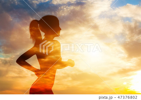 Silhouette of a running woman on sky background. Silhouette of a running woman on sky background. 47376802