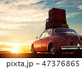 Retro red car with luggage on roof rack at sunset. Travel, vacation concepts. 47376865