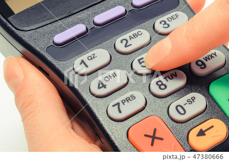 Hand using payment terminal 47380666