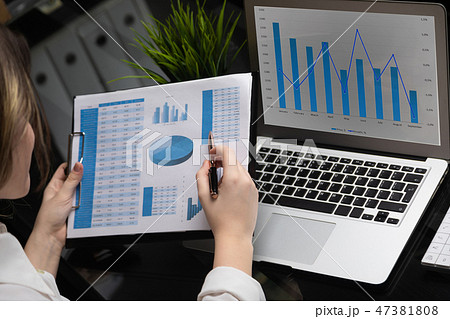 Businessman analyzing investment charts with laptop. Accounting 47381808