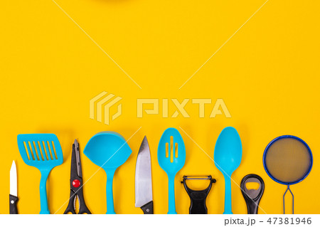 Kitchen utensils isolated on yellow background Kitchen utensils isolated on yellow background 47381946