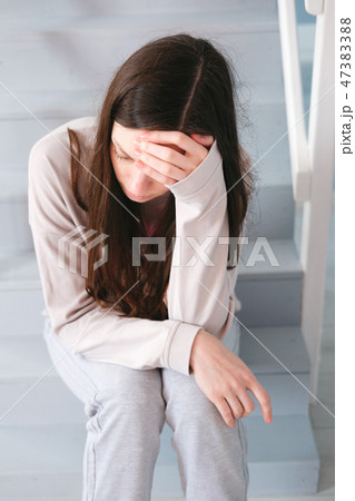 A woman sitting alone and depressed A woman sitting alone and depressed 47383388