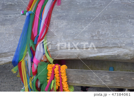 Multi-colored fabrics on ancient wooden logs.Scrap 47384061