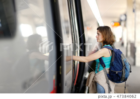 Young woman with backpack take the train. 47384062