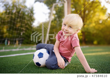 Boy having fun playing a soccer/football game 47384610