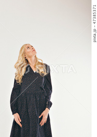 model posing in a dress on a white background. Girl shows clothes model posing in a dress on a white background. Girl shows clothes 47385371