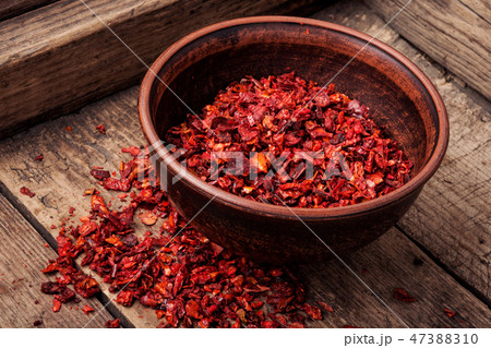 Heap of red pepper flakes 47388310