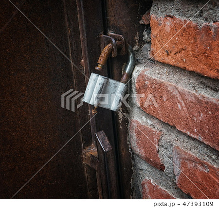 Old rustic gate lock closeup Old rustic gate lock closeup 47393109