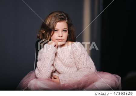 Beautiful young model in a peach color knitted sweater. Fashion makeup and hairstyle Beautiful young model in a peach color knitted sweater. Fashion makeup and hairstyle 47393329