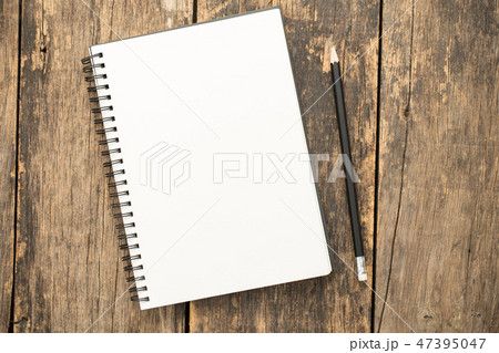 blank paper and pencils on old wooden table 47395047