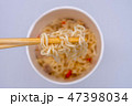 Hot instant noodle in the wooden chopsticks 47398034