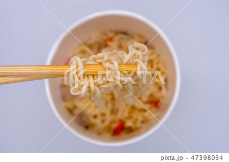 Hot instant noodle in the wooden chopsticks 47398034