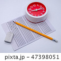 Answers sheet with yellow sharp pencil, clock 47398051