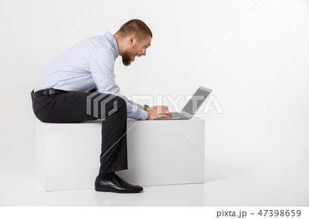 young handsome man in shirt and tie using laptop young handsome man in shirt and tie using laptop 47398659
