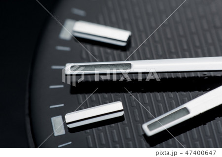 Close up clockwise on black clock face background. 47400647