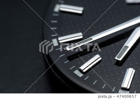 Close up clockwise on black clock face background. Close up clockwise on black clock face background. 47400657