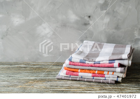 Stack of kitchen towels or napkins on rustic table Stack of kitchen towels or napkins on rustic table 47401972