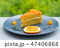 A sliced piece of orange cake on grey dish  47406868
