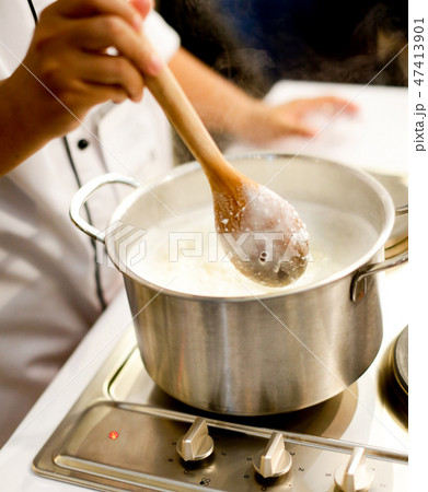 Chef cooking food in the kitchen, preparing food 47413901