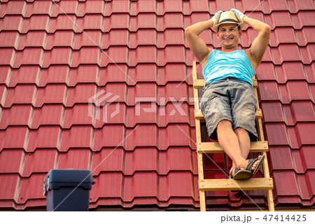Happy man posing on the stairs Happy man posing on the stairs 47414425